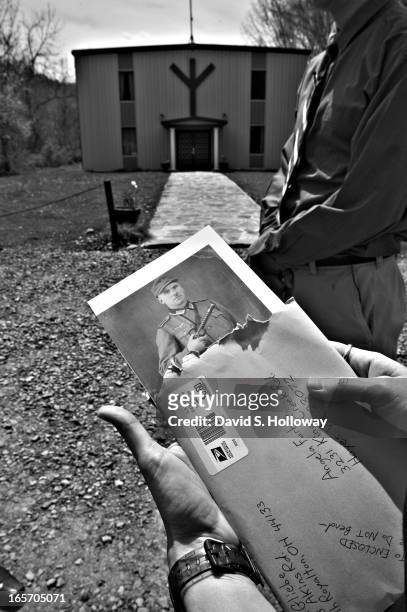 Erica Gliebe looks at a photo of her husband Erich Gliebe's grandfather, whom he claims was a member of the german army during World War II, at the...