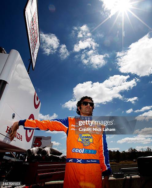 Dario Franchitti of Scotland, driver of the Target Chip Ganassi Racing Banana Boat Honda stretches in pit lane prior to practice for the Honda Indy...