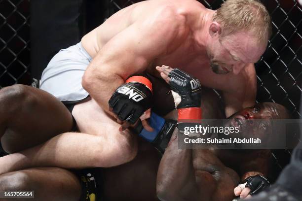 Brock Larson of United States of America grounds and pounds Melvin Manhoef of Netherlands during the One Fighting Championship at Singapore Indoor...