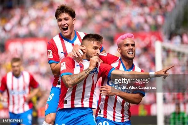 Cristian Portugues 'Portu' of Girona FC celebrates with his teammates Pablo Torre and Yan Couto after scoring his team's first goal during the LaLiga...