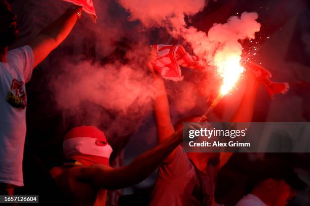 Fans are seen with flares during the Bundesliga match between Eintracht Frankfurt and 1. FC Köln at Deutsche Bank Park on September 03, 2023 in...