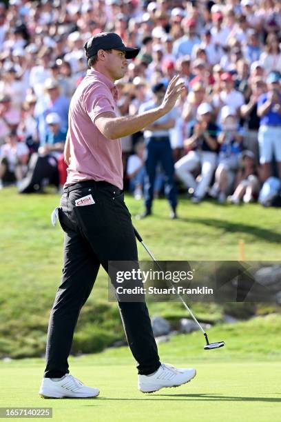 Ludvig Aberg of Sweden acknowledges the crowd after finishing his round on the 18th hole during Day Four of the Omega European Masters at...