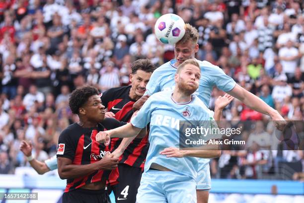 Steffen Tigges of 1.FC Köln wins a header whilst under pressure from Robin Koch and Jessic Ngankam of Eintracht Frankfurt during the Bundesliga match...