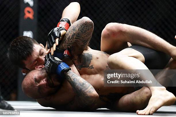 Shinya Aoki of Japan executes a rear naked choke win over Kotetsu Boku of Japan for the Lightweight World Championship bout during the One Fighting...