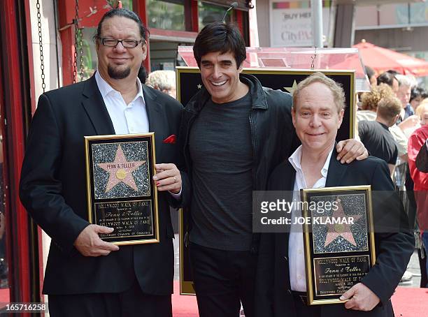 American illusionists and entertainers Penn Jillette and Teller pose with magician David Copperfield while being honored with a star on the Hollywood...
