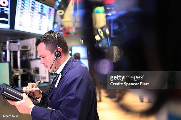 Traders work on the floor of the New York stock Exchange at the end of the trading day on April 5, 2013 in New York City. Following news of a...