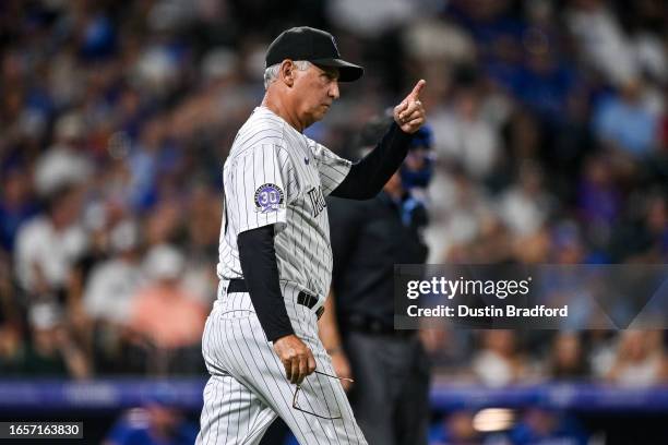 Bud Black of the Colorado Rockies walks to the mound to make a pitching change in the seventh inning against the Toronto Blue Jays at Coors Field on...