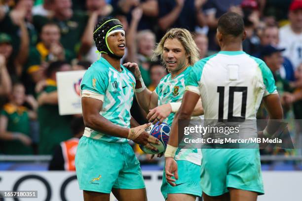 Kurt-Lee Arendse of South Africa celebrates scoring his sides second try with team mates Faf de Klerk and Manie Libbok during the Rugby World Cup...