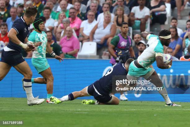 South Africa's flanker and captain Siya Kolisi is tackled by Scotland's scrum-half Ben White during the France 2023 Rugby World Cup Pool B match...