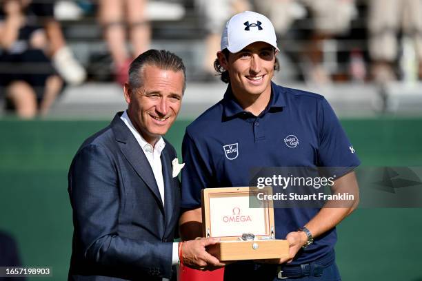 Cedric Gugler of Switzerland receives a price from Raynald Aeschlimann, OMEGA CEO and President at the prize presentation during Day Four of the...