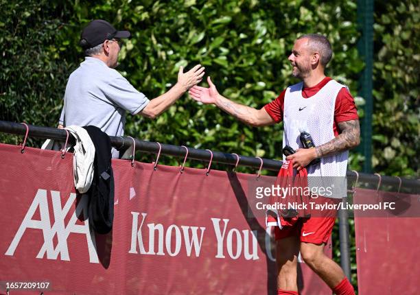 Former Liverpool coach Hugh McAuley is greetind by player coach Jay Spearing of Liverpool before the PL2 game at AXA Training Centre on September 03,...