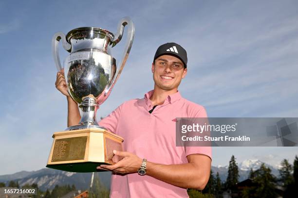 Ludvig Aberg of Sweden poses with the Omega European Masters trophy during Day Four of the Omega European Masters at Crans-sur-Sierre Golf Club on...