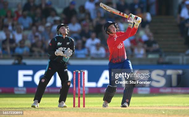 New Zealand wicketkeeper Tim Seifert looks on as England batsman Harry Brook hits out only to be caught during the 3rd Vitality T20I between England...