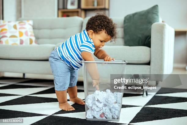 this is more interesting than any toy - baby boy stock pictures, royalty-free photos & images