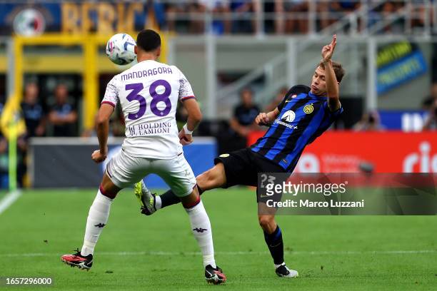 Nicolo Barella of Inter Milan battles for possession with Rolando Mandragora of ACF Fiorentina during the Serie A TIM match between FC Internazionale...