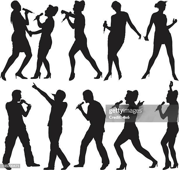 people singing into microphones - holding microphone stock illustrations