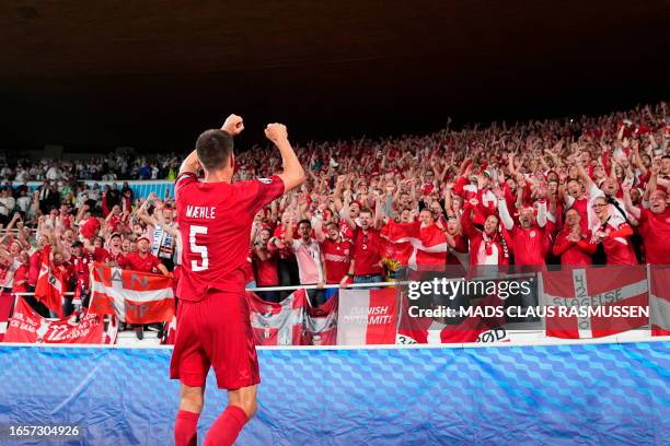 Denmark's defender Joakim Maehle celebrates with the fans after the UEFA EURO 2024 qualifying football match Finland v Denmark in Helsinki, Finland,...