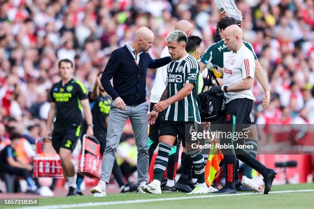 Lisandro Martínez of Manchester United with Head Coach Erik ten Hag as he is subbed following an injury during the Premier League match between...