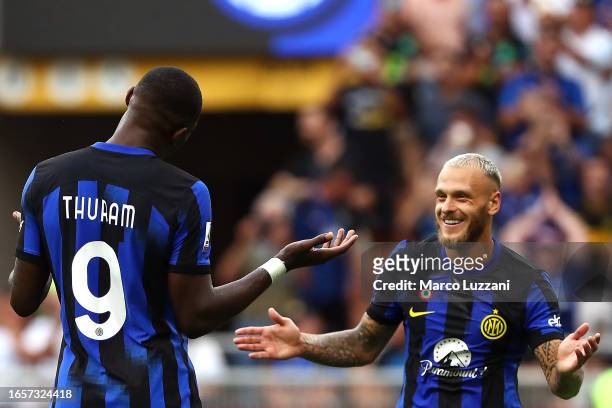 Marcus Thuram of Inter Milan celebrates after scoring the team's first goal with Federico Dimarco during the Serie A TIM match between FC...
