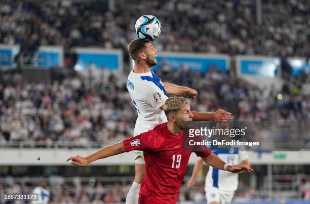 Arttu Hoskonen of Finland and Jonas Wind of Denmark battle for the ball during the UEFA EURO 2024 European qualifier match between Finland and...