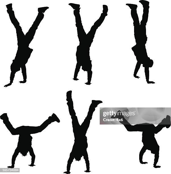 agile men standing on hands - breakdancing stock illustrations