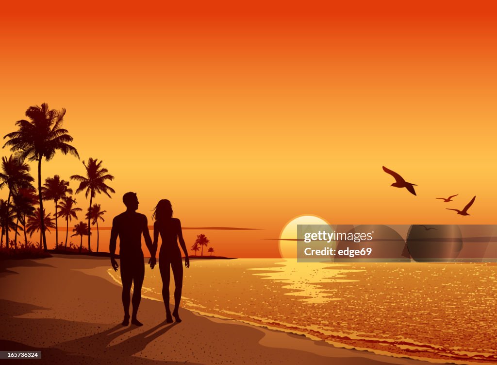 Couple walking on the Beach at Sunset