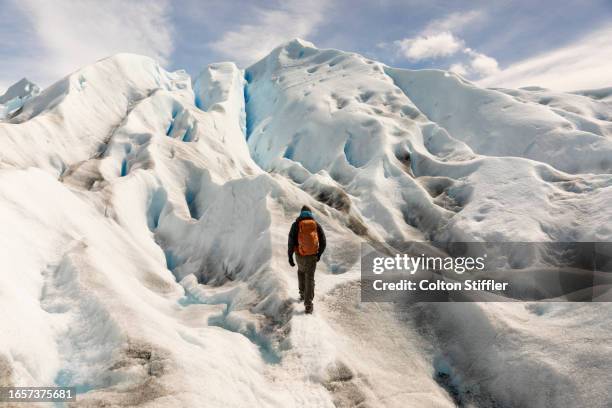 man hiking on perito moreno glacier, el calafate, santa cruz province, argentina. - cruz stock pictures, royalty-free photos & images