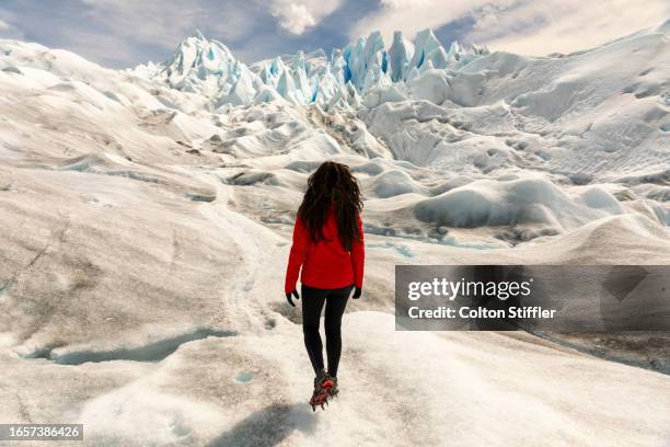 woman with red jacket in front of perito moreno glacier, el calafate, santa cruz province, argentina. - cruz stock pictures, royalty-free photos & images