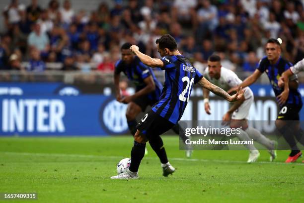 Hakan Calhanoglu of Inter Milan scores the team's third goal from the penalty spot during the Serie A TIM match between FC Internazionale and ACF...