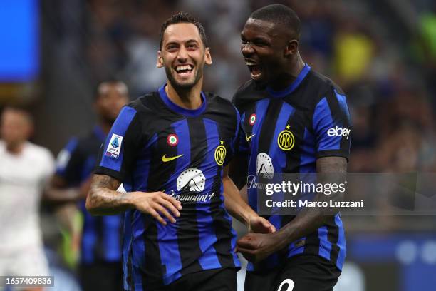 Hakan Calhanoglu of Inter Milan celebrates with Marcus Thuram after scoring the team's third goal during the Serie A TIM match between FC...