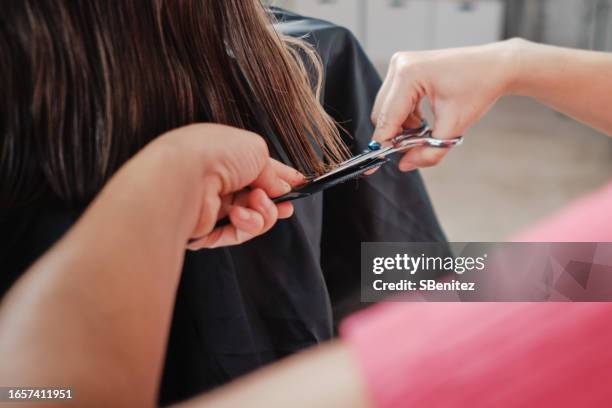 hairdresser cutting a girl's hair - stylist bildbanksfoton och bilder