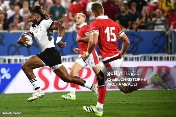 Fiji's outside centre and captain Waisea Nayacalevu runs with the ball to score a try during the France 2023 Rugby World Cup Pool C match between...