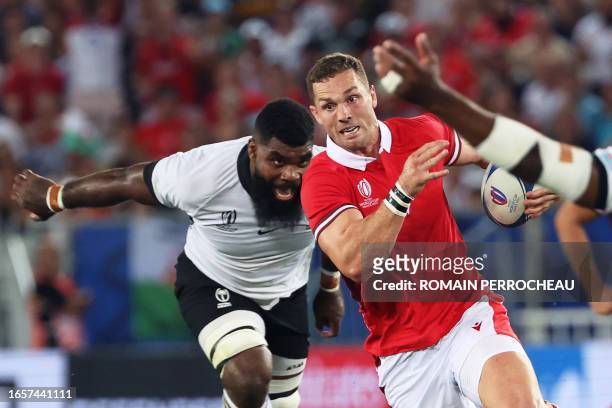 Wales' outside centre George North runs with the ball during the France 2023 Rugby World Cup Pool C match between Wales and Fiji at Stade de Bordeaux...