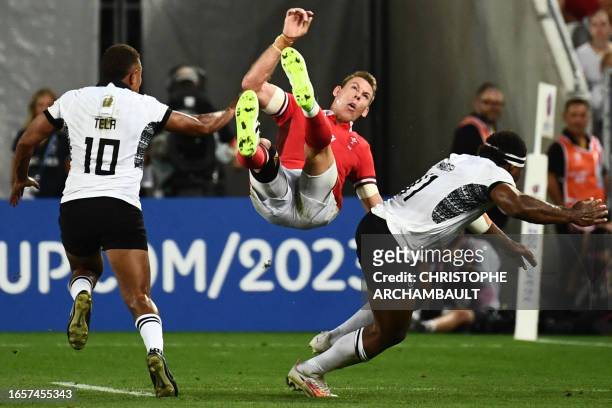 Wales' full-back Liam Williams flips in the air during the France 2023 Rugby World Cup Pool C match between Wales and Fiji at Stade de Bordeaux in...