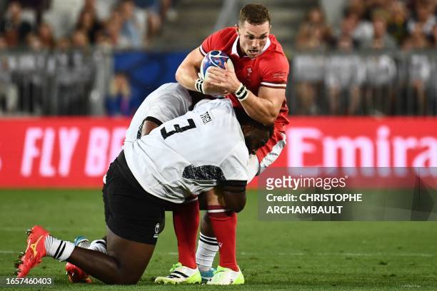 Wales' outside centre George North is tackled by Fiji's tighthead prop Luke Tagiduring the France 2023 Rugby World Cup Pool C match between Wales and...