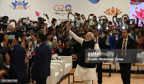 Prime Minister Narendra Modi greets the media and supporting staff to success for the G-20 summit India arrives at International Media Centre at the...