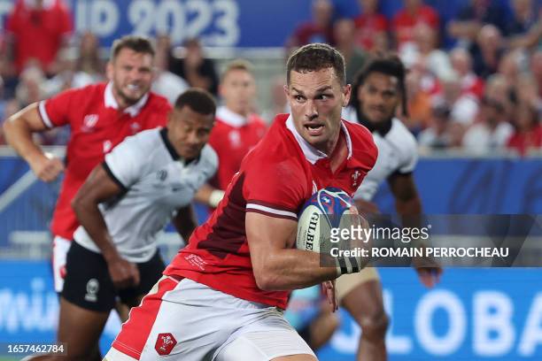 Wales' outside centre George North runs to score a try during the France 2023 Rugby World Cup Pool C match between Wales and Fiji at Stade de...