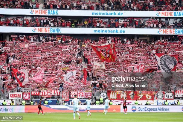 Fans of Eintracht Frankfurt hold up their scarves during the Bundesliga match between Eintracht Frankfurt and 1. FC Köln at Deutsche Bank Park on...