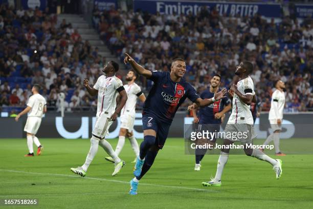 Kylian Mbappe of PSG celebrates after scoring a first half penalty to give the side a 1-0 lead during the Ligue 1 Uber Eats match between Olympique...