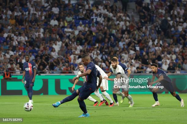 Kylian Mbappe of PSG scores a first half penalty to give the side a 1-0 lead during the Ligue 1 Uber Eats match between Olympique Lyonnais and Paris...