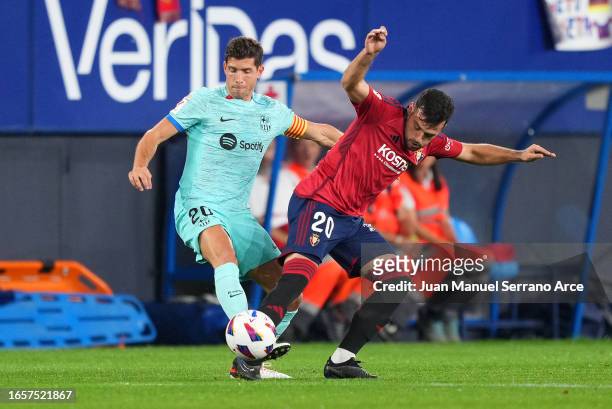 Sergi Roberto of FC Barcelona battles for possession with Jose Arnaiz of CA Osasuna during the LaLiga EA Sports match between CA Osasuna and FC...