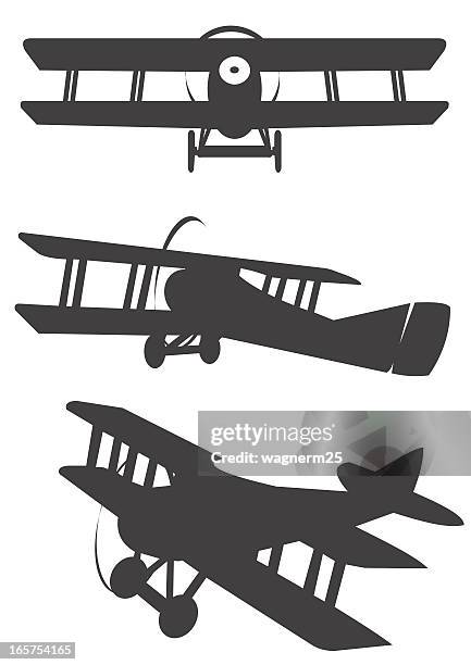 three classic propeler biplane silhouetes - biplane stock illustrations