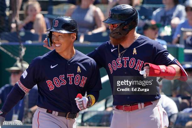 Masataka Yoshida of the Boston Red Sox celebrates his three-run home run with Justin Turner in the third inning against the Kansas City Royals at...
