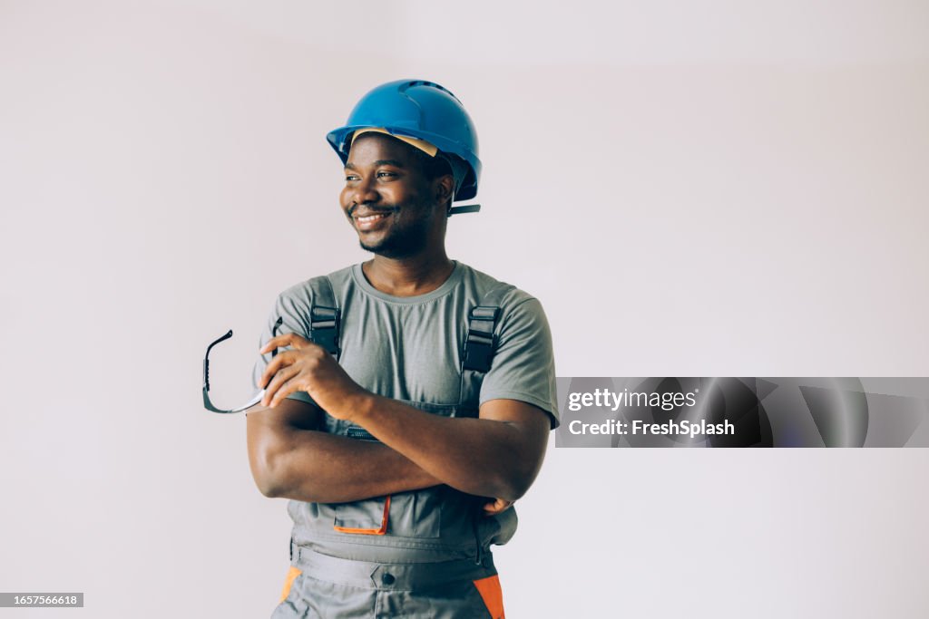 Portrait of a Happy African American Construction Worker Wearing a Blue Helmet