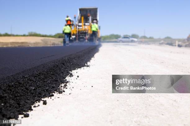 blacktop paving road with paver and dump truck - road works stock pictures, royalty-free photos & images