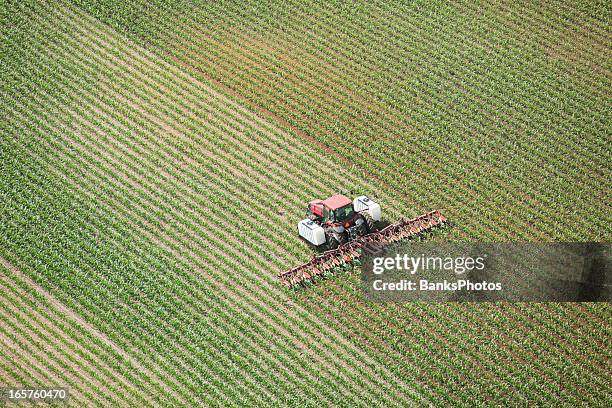 tractor applying liquid nitrogen fertilizer to corn field - nitrogen stock pictures, royalty-free photos & images