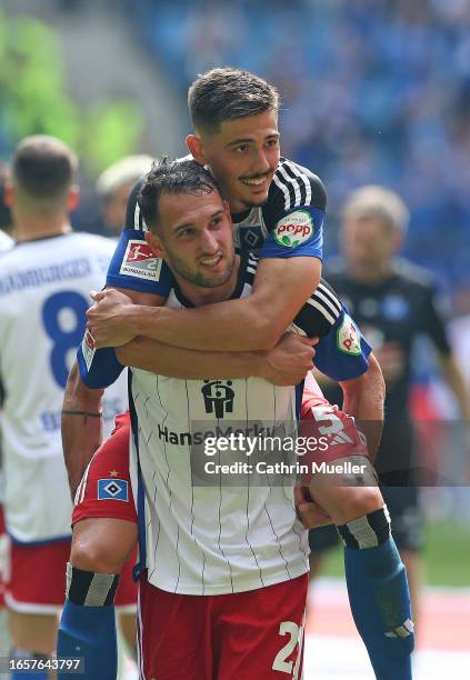 Levin Oztunali and Dennis Hadzikadunic of Hamburger SV celebrate following the team's victory during the Second Bundesliga match between Hamburger SV...