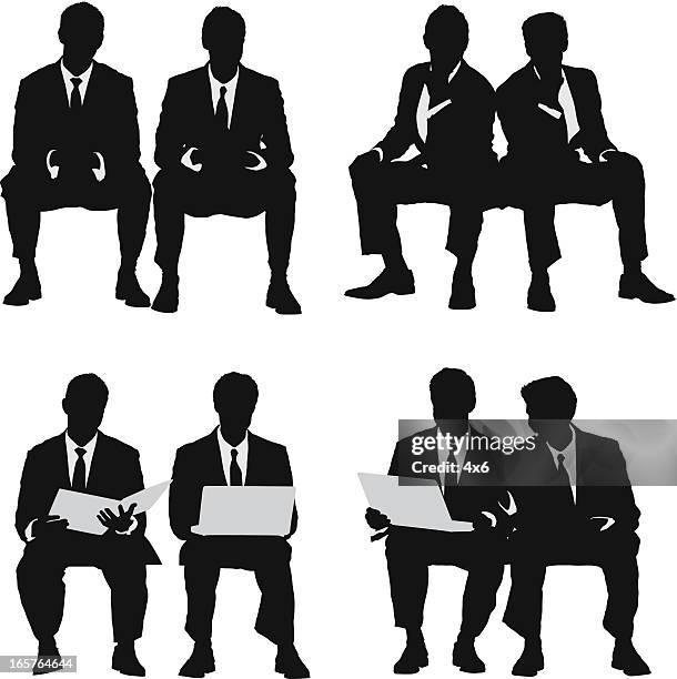 pair of young businessmen sitting - hand on chin stock illustrations