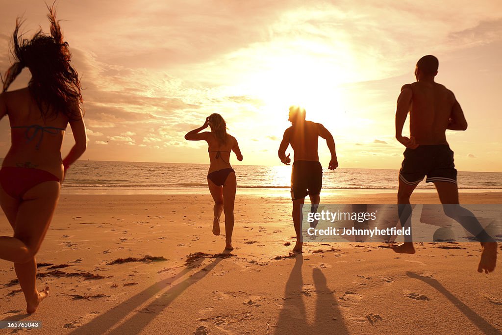 Multi ethnic friends running on the beach