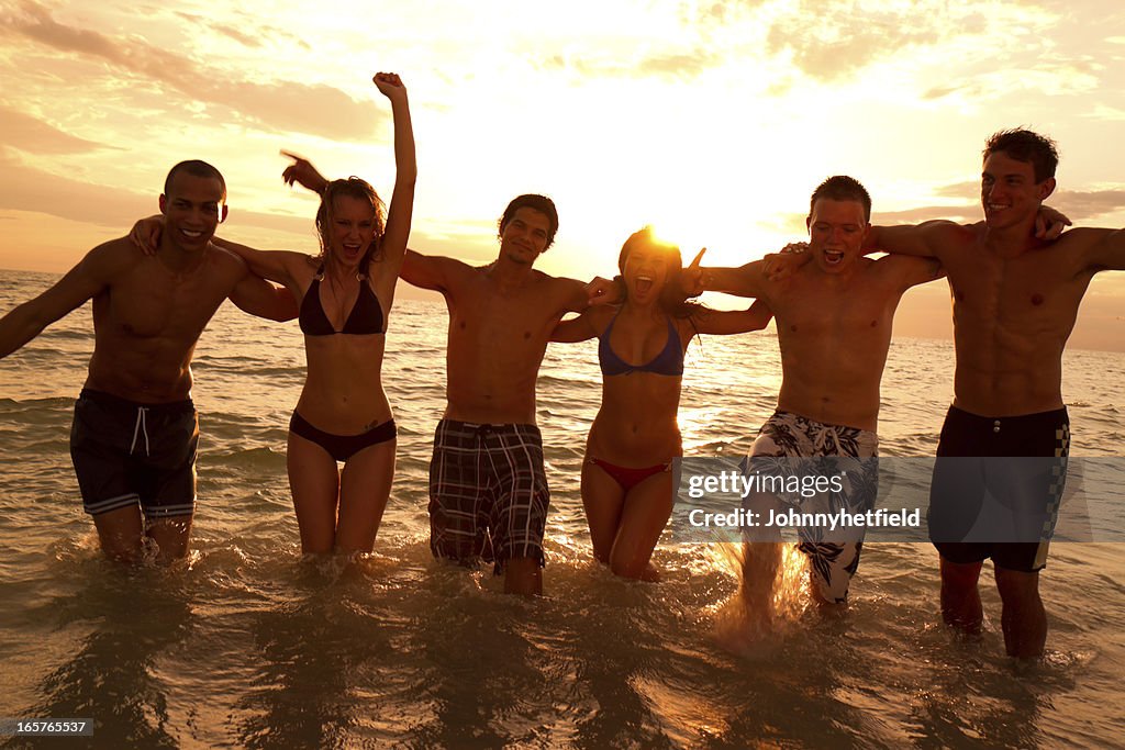 Multietnico di amici che si diverte in spiaggia